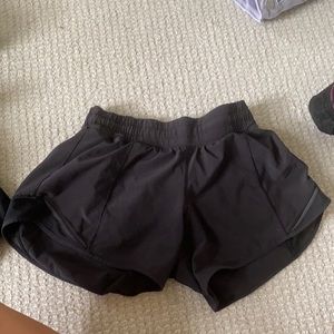 pair of black size 2 tall lulu lemon shorts.